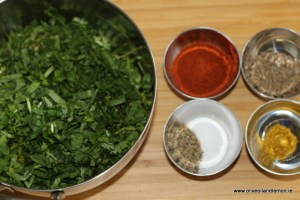 Parsley Coriander in silver bowl and spices in a set of silver bowls